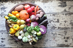 Colorful vegetables arranged by color in a bowl