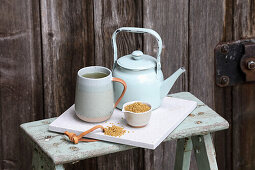 A Cup of Fenugreek Tea with Loose Tea and a Tea Pot