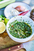 Chimichurri in a bowl on a garden table