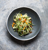 Vegan zucchini noodles with macadamia and golden raisins