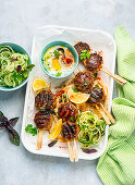 Meatballs on a skewer with cucumber salad