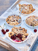 Small cherry crumble on wooden tray