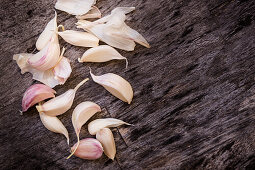 Fresh garlic cloves on a wooden background