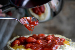 Preparing summer berry pizza