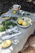 Table set with lemons, in the garden