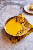 Creamy soup of roasted butternut squash with garlic cheese bread