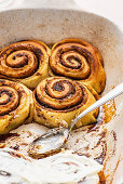 Homemade Cinnamon rolls against a pink background