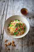 Fried noodles with vegetables, fish sauce and crispy fried dried prawns