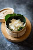 Steamed sticky rice in banana leaf