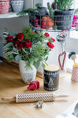 Christmas bouquet of red roses, pine twigs, and eucalyptus