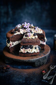A chocolate sandwich cake with blackberries