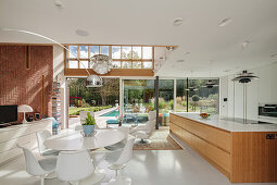 Open living room in the architect's house with floor to ceiling windows to the garden