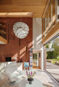 Sunny living room with window front in an architect's luxurious house