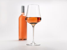 A glass and a bottle of rosé wine
