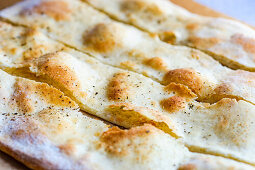Freshly baked Italian focaccia cut into strips (close up)