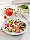 Summer radish salad with snack cucumbers and feta cheese