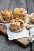 Vegan yeast buns filled with apple-cinnamon pieces and almonds