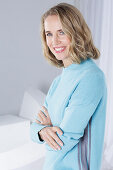 Blond woman wearing a light blue sweater