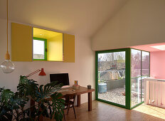 Study with houseplants in the converted attic with terrace view