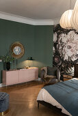 Illuminated pink sideboard in front of green wall and floral wallpaper in the bedroom
