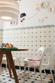 Breakfast table with minimalist chairs in a tiled kitchen