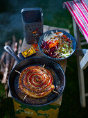 Sticky apple cider mustard sausage snail with raw vegetable salad