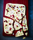 Broken white chocolate with raspberries, coconut and pistachios