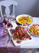 Moroccan lamb shoulder with sticky pomegranate glaze, couscous and carrot salad