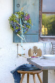 Wreath of hydrangeas and love-in-a-mist on old shutters