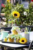 Jam jars decorated with ornamental apples and bouquet of sunflowers