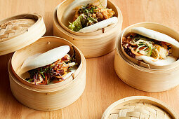 Bao buns presented in wooden steaming baskets