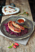 Wild boar sausage with red sauerkraut and rosehip ketchup