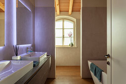 Ensuite bathroom with double vanity and illuminated mirrors