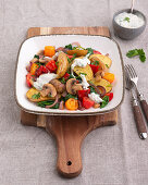 Warm potato salad with peppers, mushrooms, spinach and tomatoes