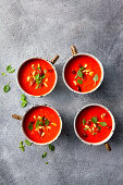 Red pepper soup with chilli, garnished with fried bacon and pine nuts