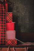 Christmas gifts wrapped with red chequered ribbon
