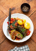 Savoy cabbage roulades in a delicious tomato sauce with boiled potatoes