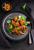 Fried bread dumplings on mushroom ragout with chickpeas and lamb's lettuce, vegan