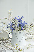 Enamel pot filled with iris and plum blossom sprigs