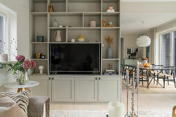 Living room wall as room divider, view of dining area