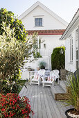 White deck chairs on wooden terrace