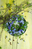 Old baking tin with wreath of forget-me-nots and birch twigs