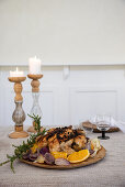 Festive table setting with roast chicken and candles