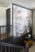 Staircase with black banister and poster with bird garden motif