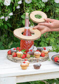 Self-made etagere for a bulbous bottle made of suitably cut wooden discs