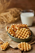 Mini waffles, with a glass of milk in the background