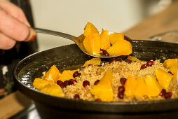 Tajine with lamb, couscous, oranges and pomegranate seeds
