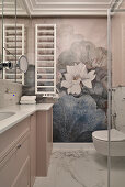 Bathroom with pink vanity unit, matching floral wallpaper and toilet