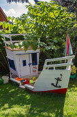 Sandbox for children as a boat in the garden