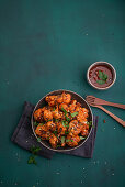 Spicy cauliflower buffalo bites with sesame seeds